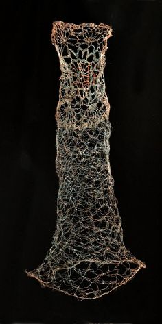 a sculpture made out of wire on a black background