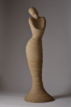 a wooden sculpture sitting on top of a white table