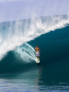 a man riding a wave on top of a surfboard