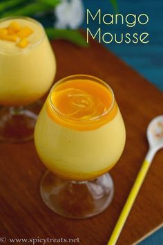 mango mousse in small glasses on a wooden tray