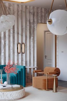 a living room filled with furniture next to a wall mounted light above a table and chair