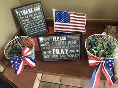 patriotic decorations and signs on a table in front of a sign that says please, soldier home to pray for your men and women