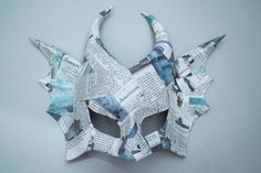 an origami mask made out of newspaper