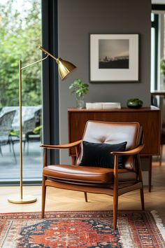 a living room with a chair, lamp and rug in front of a glass door