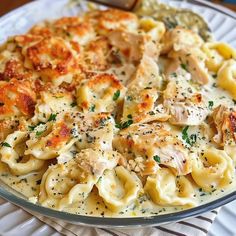 a plate full of pasta with chicken and parmesan cheese toppings on it