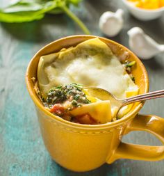 a yellow cup filled with food on top of a table