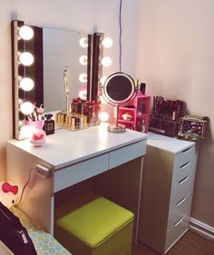 a vanity with lights on and a mirror above it