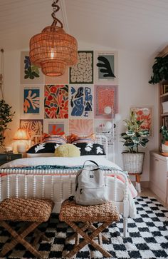 a bedroom decorated in orange, white and black with pictures on the wall above the bed