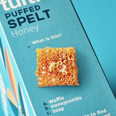 a piece of honey sitting on top of a blue box with the words tuffly spelled in it