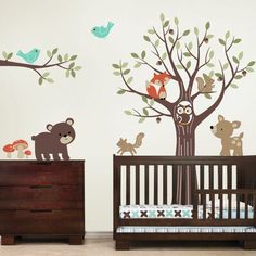 wall decals by simple shapes with animals and trees on the walls in a baby's room