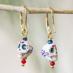 the earrings are decorated with skulls and beads