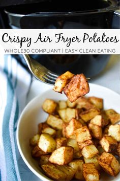 a bowl filled with potatoes next to an air fryer