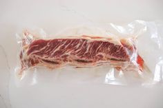 a piece of raw meat wrapped in plastic