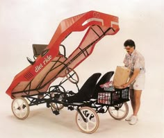 a man pushing a cart with a shopping cart attached to it