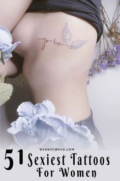 the back of a woman's stomach with tattoos on it and flowers around her