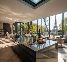 a kitchen with an island in the middle of it and a view of the eiffel tower