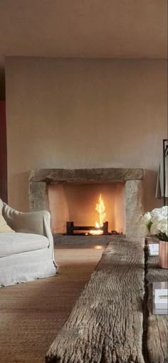 a living room filled with furniture and a fire place in the middle of the room