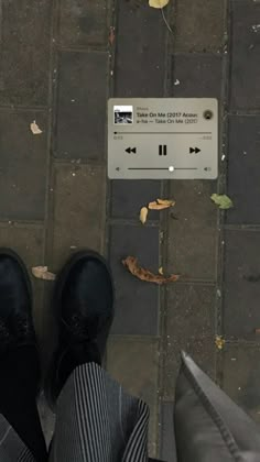 a person standing on the sidewalk with their feet up