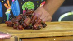 someone chopping up some food on a cutting board