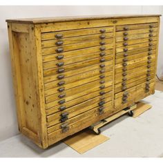 an old wooden cabinet with lots of drawers on it's sides and metal handles