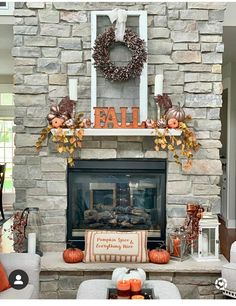 a living room decorated for fall with pumpkins and wreaths on the mantel