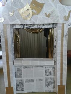 a paper mache photo frame with newspaper cutouts and gold foil on the edges