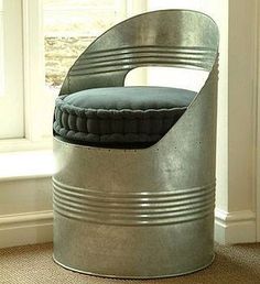 a metal bucket with a cushion in it