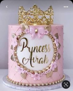 a pink princess cake with gold trim and a tiara on top that says princess araah