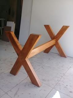 a wooden bench sitting on top of a white tiled floor