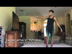 a man standing in front of a tv holding a hula hoop with the caption zagh attack