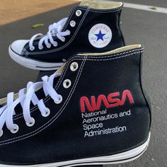 Our brand new NASA Converse design with a classy and fresh new look! These custom printed Hi-Top Converse have a NASA logo on the outside of one shoe and the NASA Rocket design on the outside of the other shoe. We buy each pair of shoes BRAND NEW. Each pair is made to order, please make sure you put in the correct shoe size before you check out. The ink is permanent and will never come off, fade away, or peel off. Made in the USA. This price includes everything: shoes, artwork, and shipping. Tha Hi Top Converse, Converse Design, Nasa Rocket, Rocket Design, Black High Top Converse, Nasa Logo, Fresh Shoes, Vans Slip On, Black High Tops