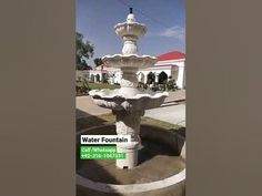 a fountain in front of a building with a sign on it that says water fountain