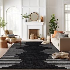 a living room with white walls and black rugs on the floor next to a fireplace