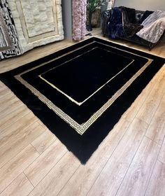 a black area rug on the floor in a living room