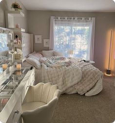 a bedroom with a large bed, dresser and mirror in it's center area