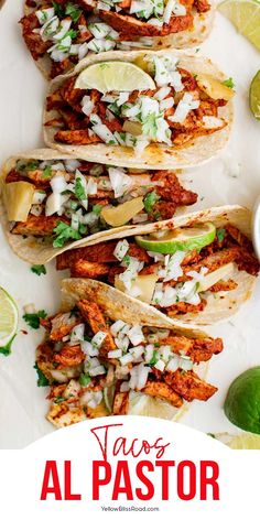 tacos al pastor with limes and cilantro on the side