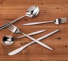 five forks, six spoons and two knives on a wooden table