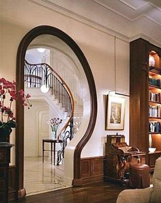 a living room filled with furniture and a spiral staircase