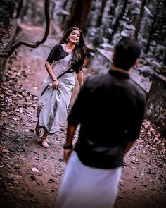 a woman walking in the woods with a man