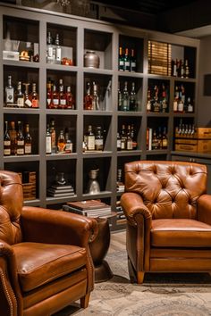 two brown leather chairs in front of shelves with liquor bottles