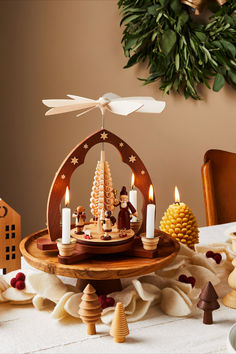 German holiday pyramids debuted in the early 1800s, long before the invention of electricity. Instead, they rely on the candles heating up the air, which then pushes up against the blades of the wheel above. The result is a spinning, eye-catching display of traditional Christmas scenes, hand-carved by artisans in Germany. Pyramid Candle, Christmas Scenes, Traditional Christmas, Christmas Traditions, Pyramid, Spinning, Hand Carved, Wheel