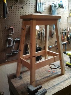 a work bench with tools on it in a workshop