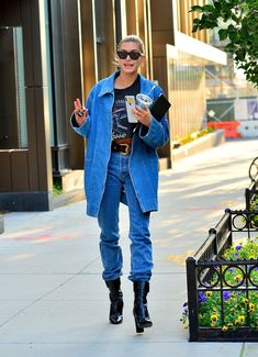 a woman walking down the street with her cell phone