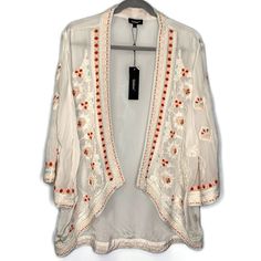 Tolani White Embroidered Open Front Karma Kimono Jacket Size: L Brand New With Tags! Retail Price $173 Please Zoom In Photos For Best View. Open Front. Stunning Embroidery. 100% Viscose. Hand Wash/Dry Clean. Measurements (Laid Flat Unstretched) Chest (Under Arm To Under Arm) 23”Flat Across Waist: 23”Flat Across Sleeve Length: 18” Sleeve Width: 8.5”Flat Across Bicep Total Length (Top Shoulder To Hem) Front 27”, Back Length 30.5” Back (Shoulder Blade Seam To Shoulder Blade Seam) 16.5” Flat Across Spring Open Front Outerwear With Floral Embroidery, Spring Outerwear With Floral Embroidery And Open Front, Fitted Long Sleeve Kimono With Floral Embroidery, Fitted White Bohemian Outerwear, White Fitted Bohemian Outerwear, Festive White Outerwear With Chikankari Embroidery, White Embroidered Open Front Kimono, White Embroidered Spring Outerwear, Spring White Embroidered Outerwear