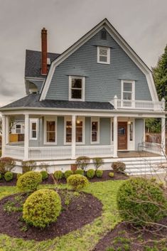 a blue house with white trim on the front