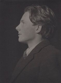 a black and white photo of a man in a suit looking off to the side