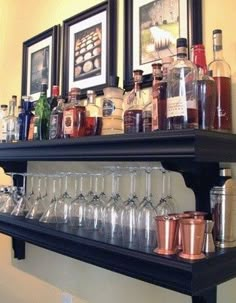 a shelf filled with lots of bottles and glasses