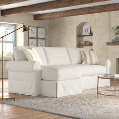 a living room with a white couch and coffee table