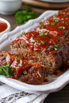 meatloaf on a plate with sauce and parsley