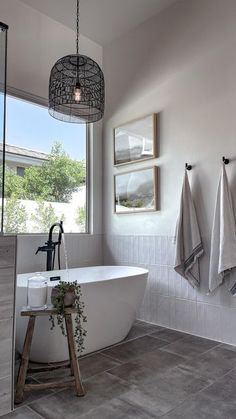 a white bath tub sitting next to a window